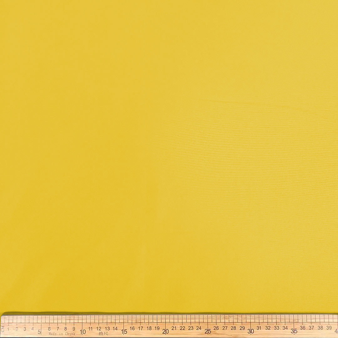 DR08931-35_1.jpg Plain Scuba A821 Yellow fabric featuring a smooth, stretchy texture and a bright, vibrant yellow color ideal for fashion and design projects.