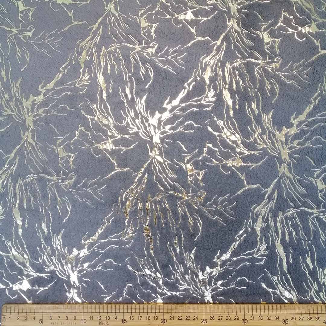 DR099995-002_1.jpg Mongolian Fleece Foiling Grey & Gold – Soft, plush fabric featuring a grey base with gold foiling, ideal for creating luxurious outerwear, accessories, and home décor with a chic, stylish finish.