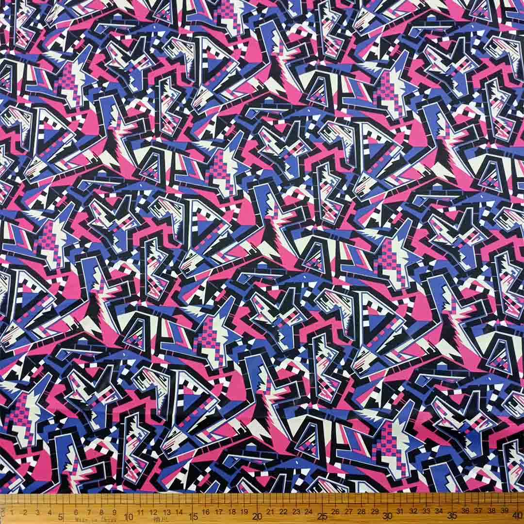 DR10996-07_1.jpg Scuba Digital Print fabric with a blue, pink, black, and white abstract design, ideal for fashion, home décor, and upholstery projects.