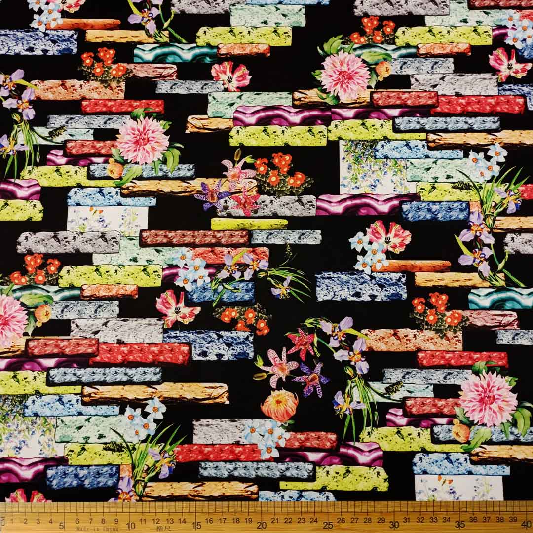 DR10996-09_1.jpg Scuba Digital Print fabric with a black brick pattern and floral prints, ideal for fashion, home décor, and upholstery projects.