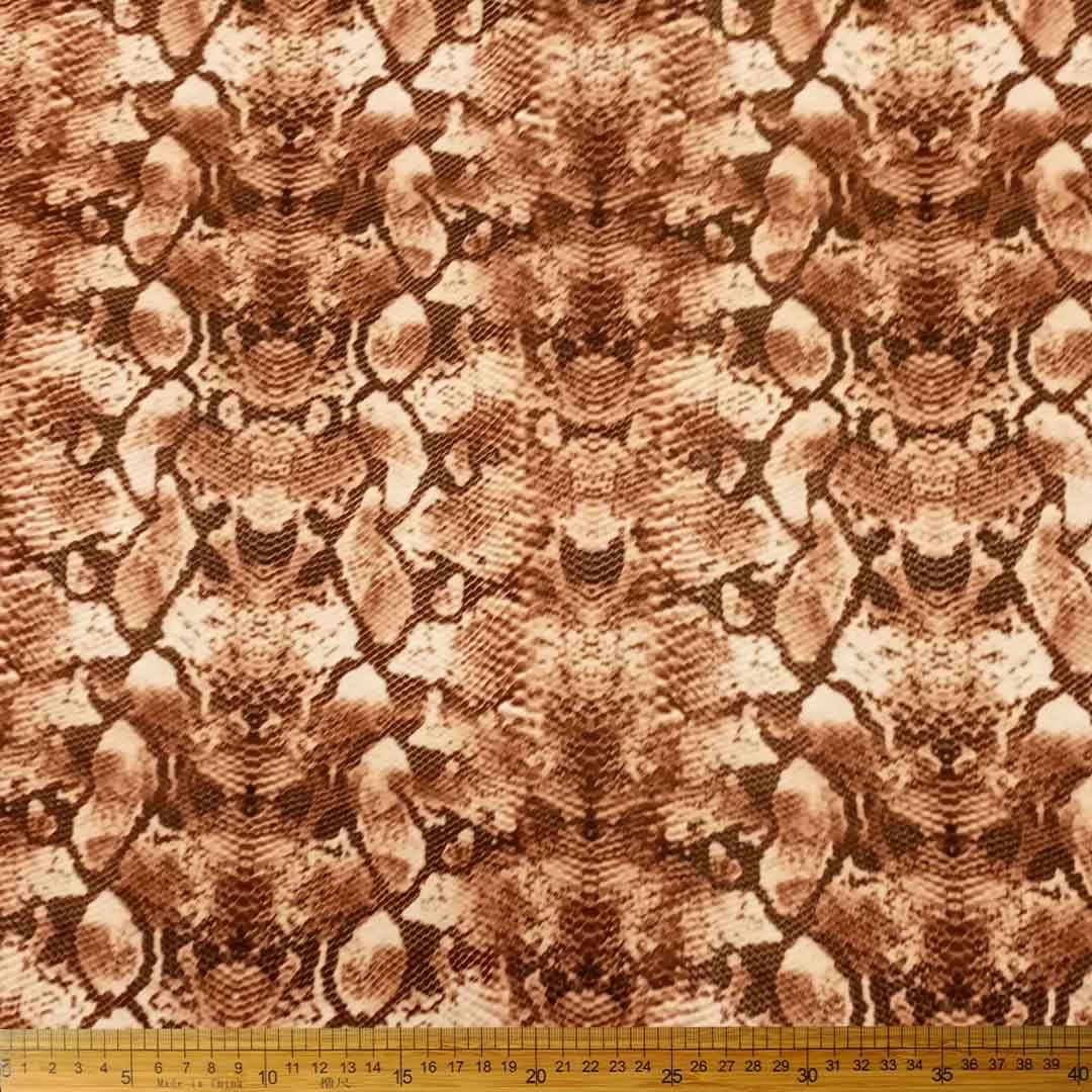 DR10996-10_1.jpg Scuba Digital Print Brown Snake Print fabric featuring a bold snake pattern in brown, ideal for creating fashionable clothing pieces.